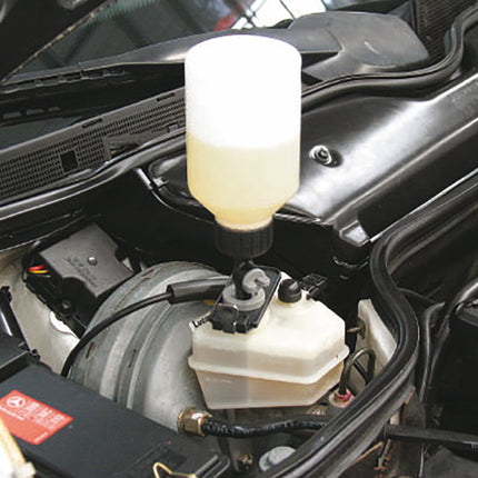 auto filler bottle shown attached to the brake fluid reservoir on a vehicle