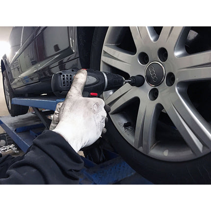 the mechanic is using a drill and a guide from the locking wheel nut removal tool to remove the nut from the wheel